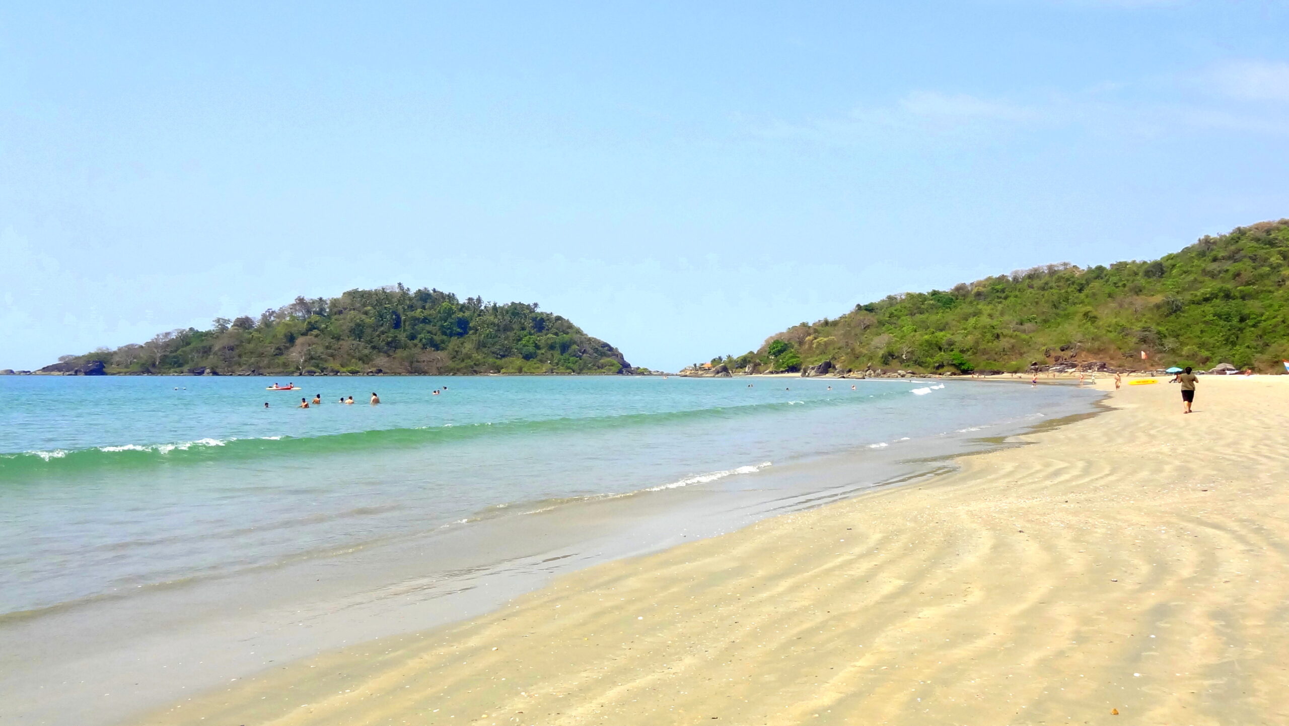 Golden sand beach with palm trees in Goa, India